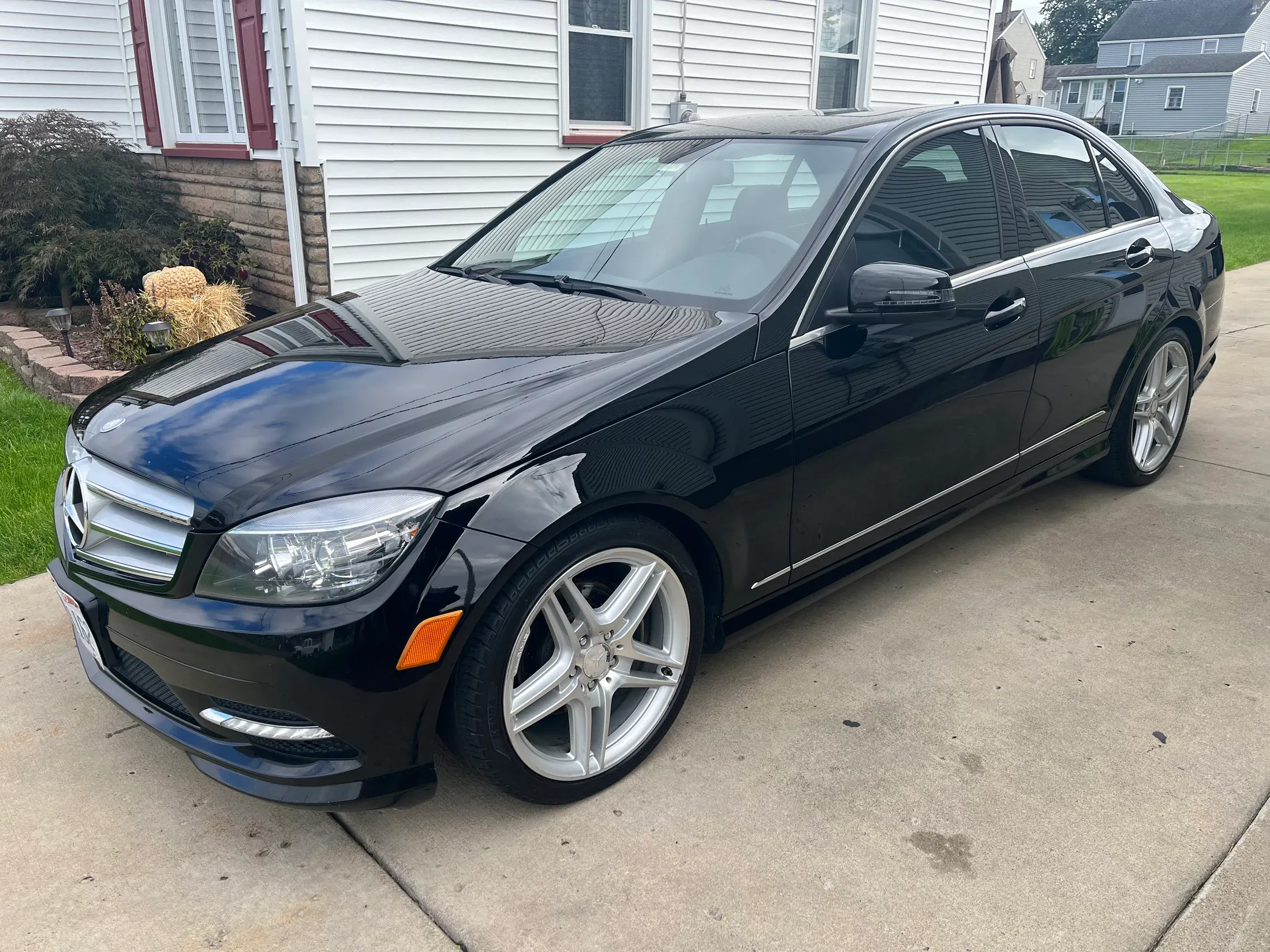 Black Mercedes-Benz sedan showing a glossy reflective finish.