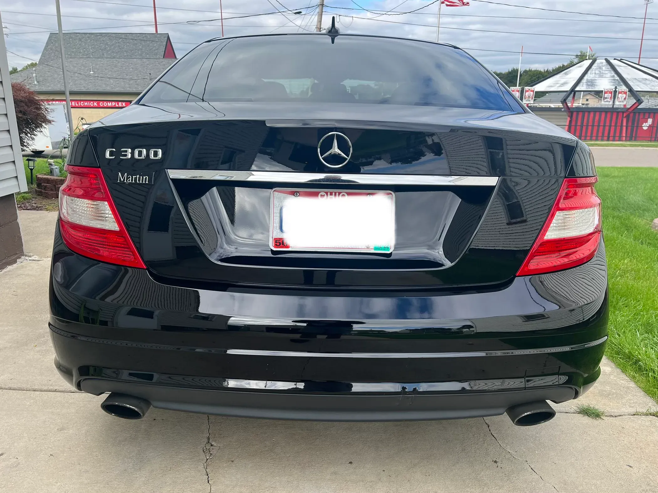 Rear view of two detailed black Mercedes-Benz sedans.