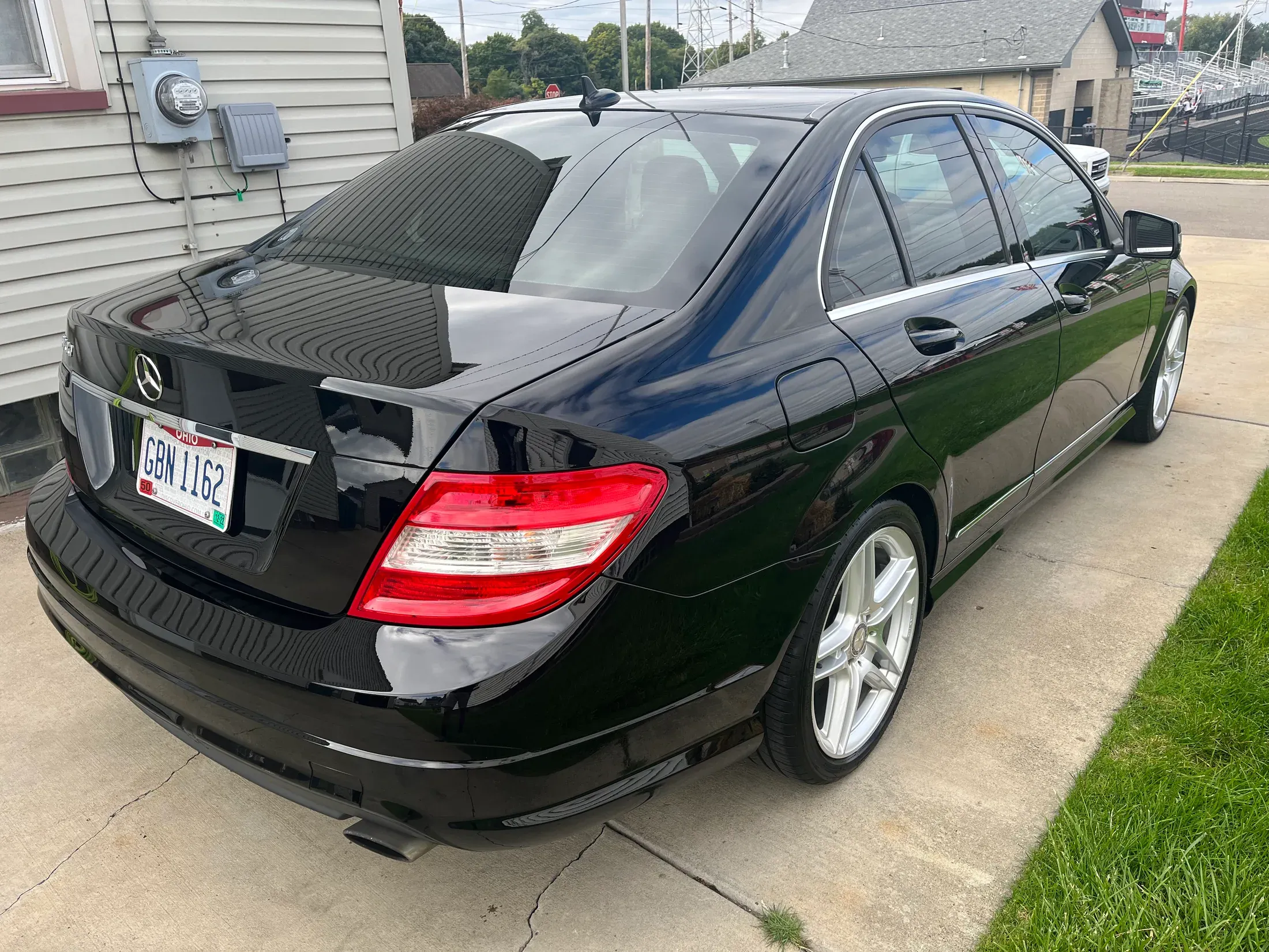 Two polished black Mercedes-Benz sedans parked side by side.