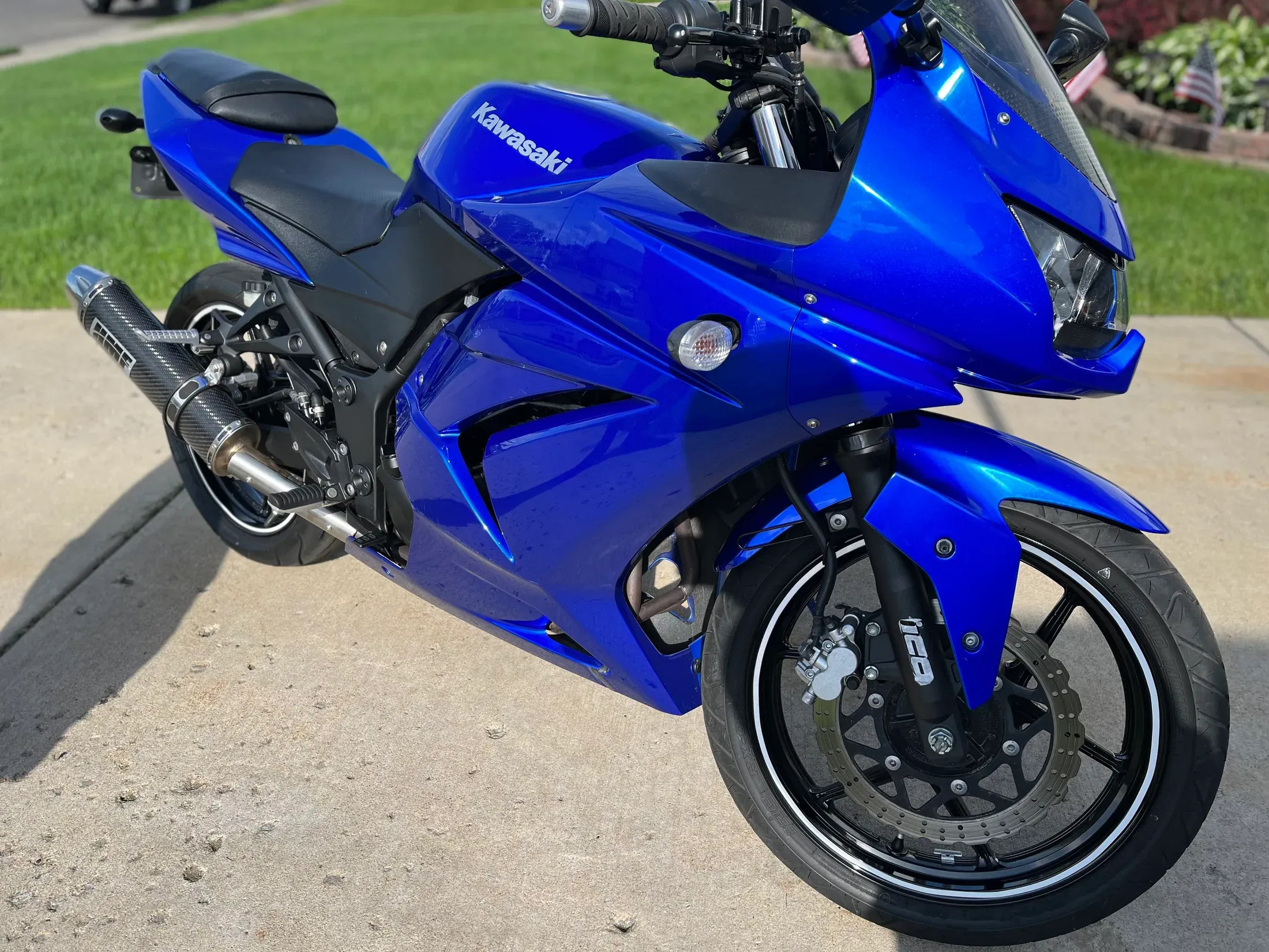Blue Kawasaki motorcycle showing its polished paint and exhaust.