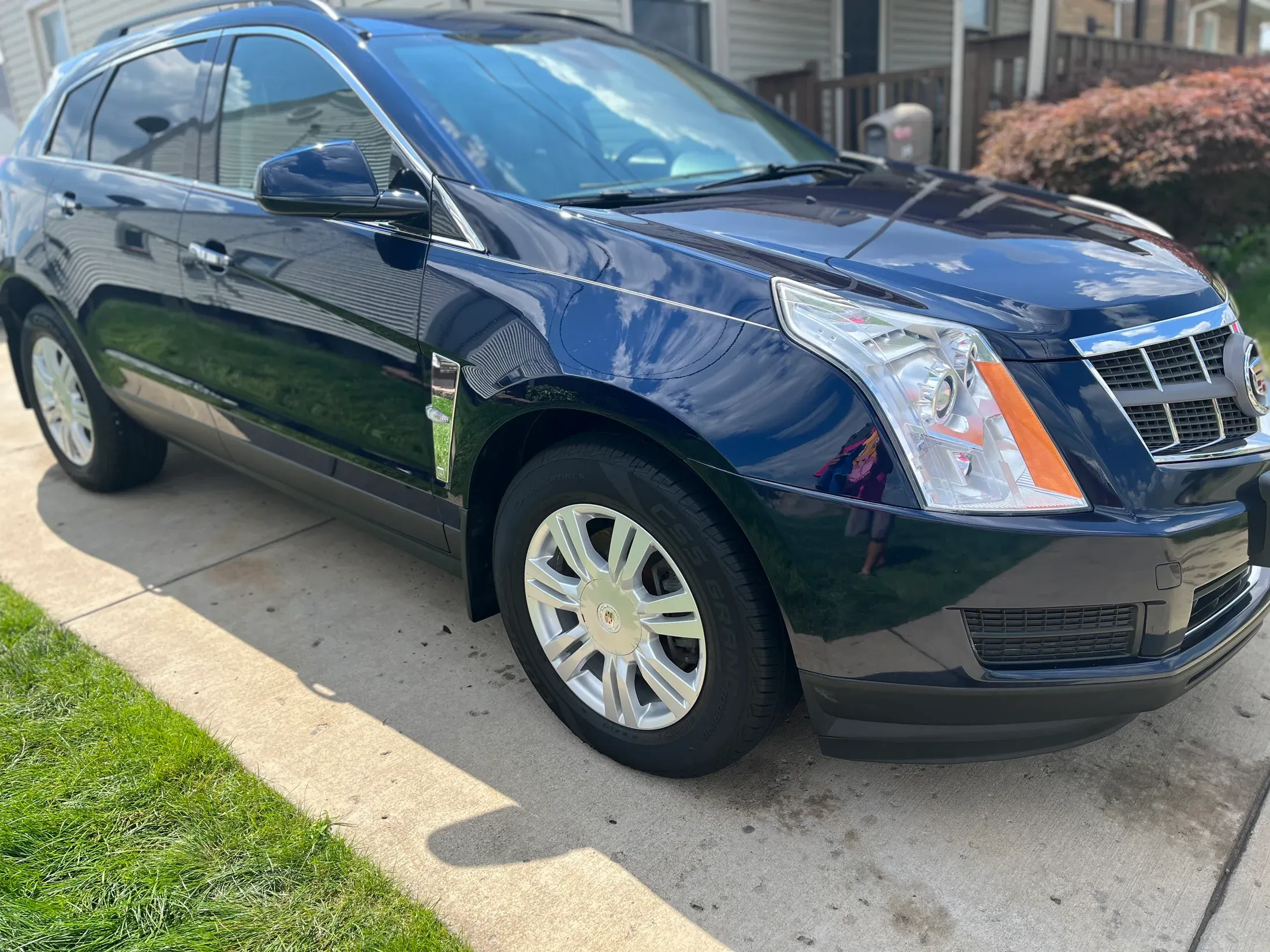 Detailed dark blue Cadillac SRX viewed from the front quarter.