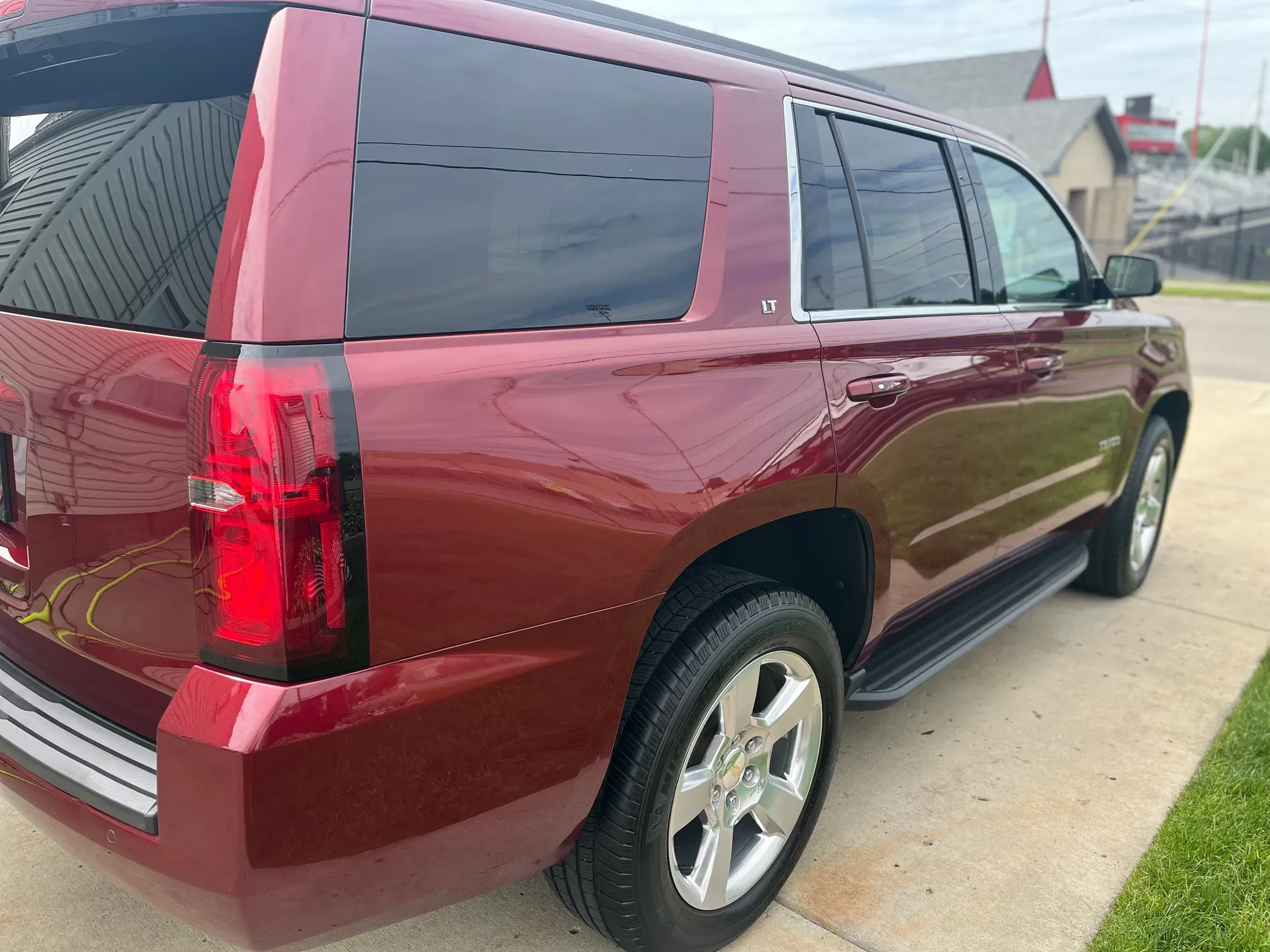 Detailed burgundy Chevrolet Tahoe from the side.