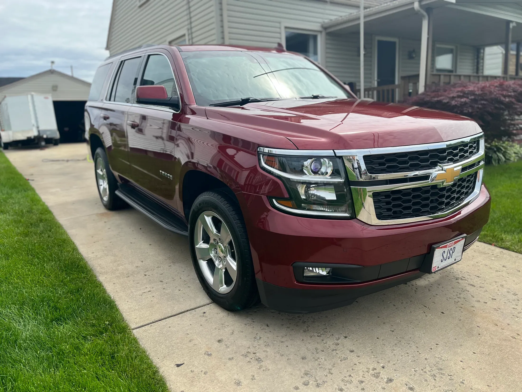 Glossy burgundy Chevrolet Tahoe viewed from the front quarter.