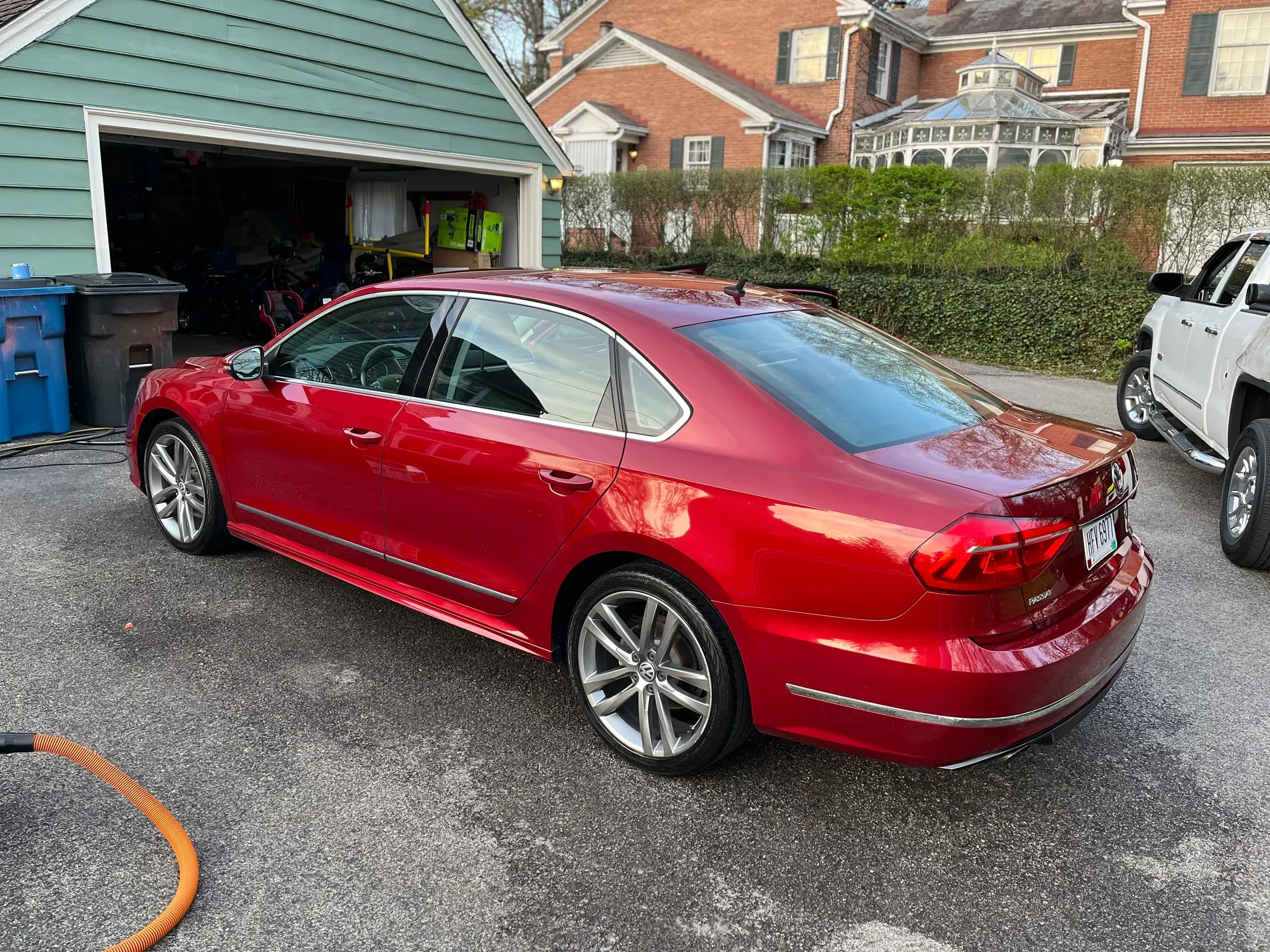 Detailed red Volkswagen sedan parked beside a touring motorcycle.
