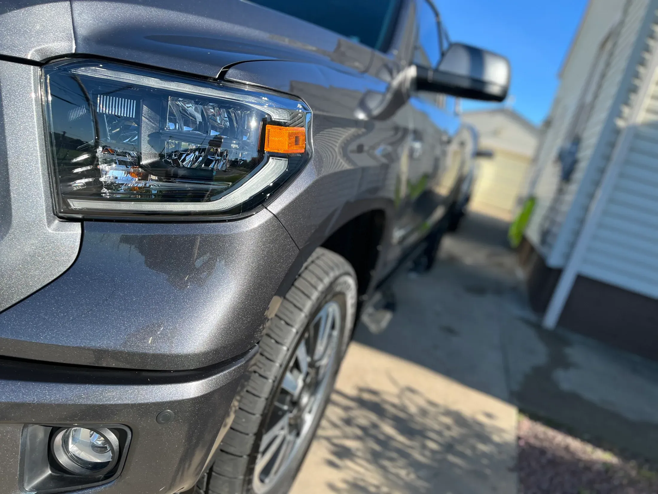 Polished front corner of a gray Toyota Tundra.