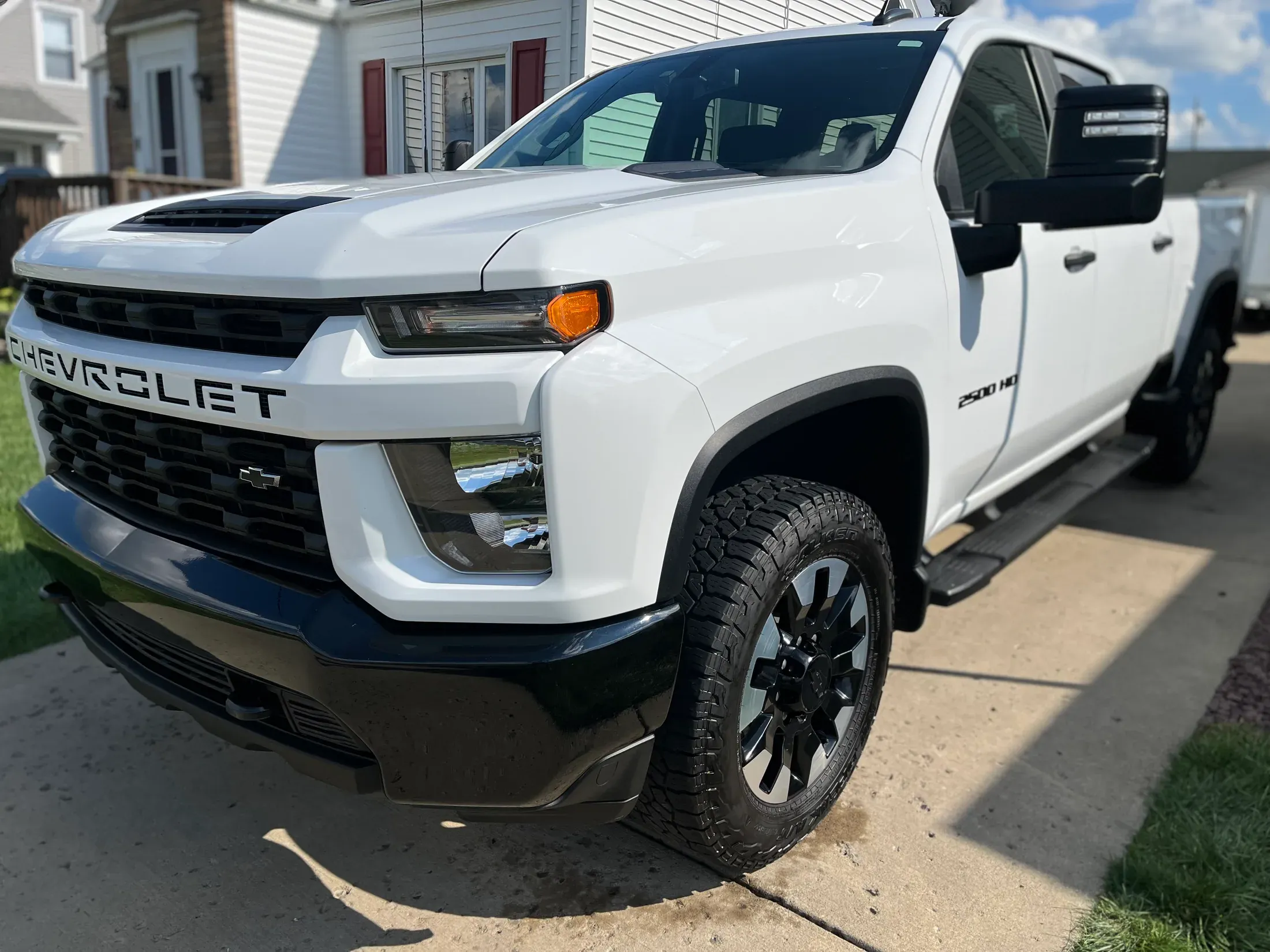 Detailed white Chevrolet Silverado HD from the side.